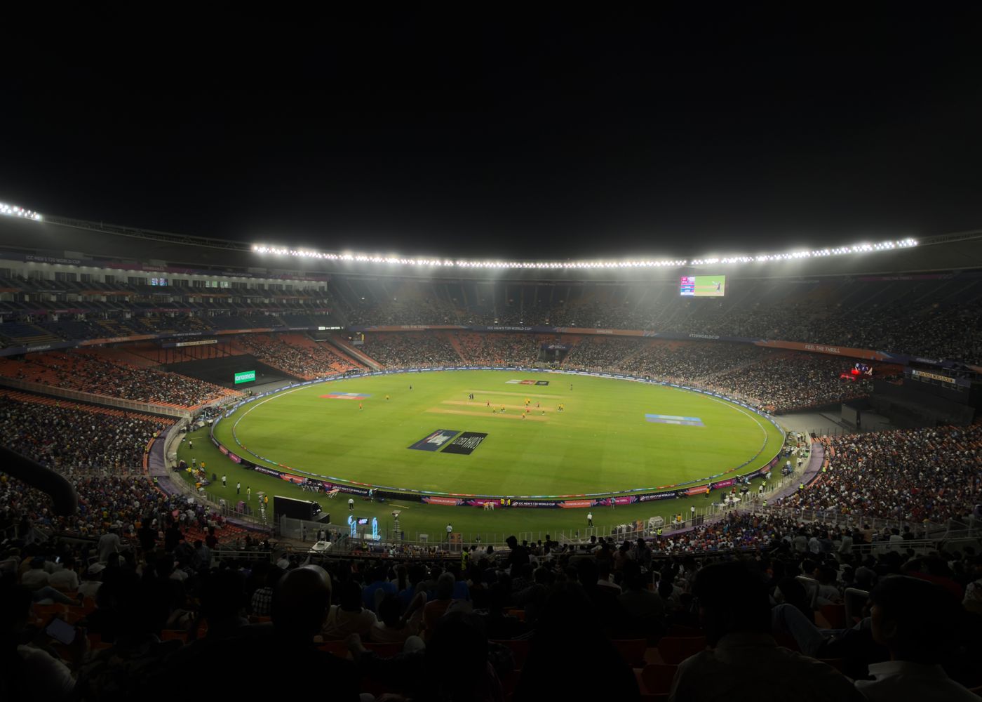 Night cricket match under stadium floodlights