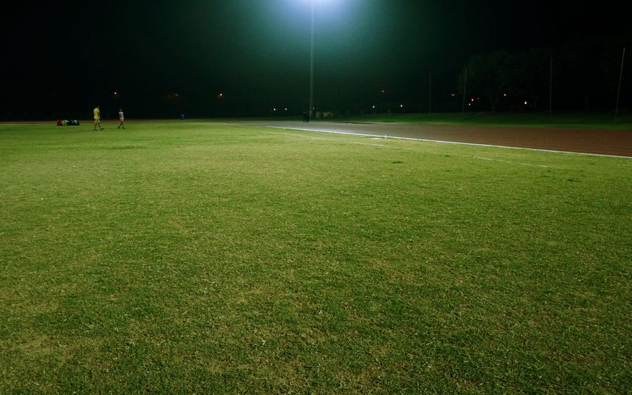 Floodlit football stadium during a night match