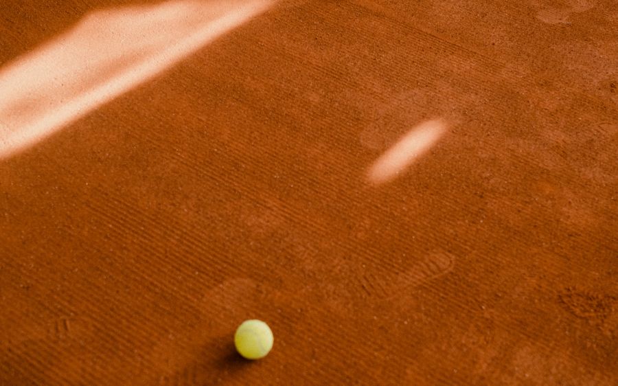 Tennis player serving on court